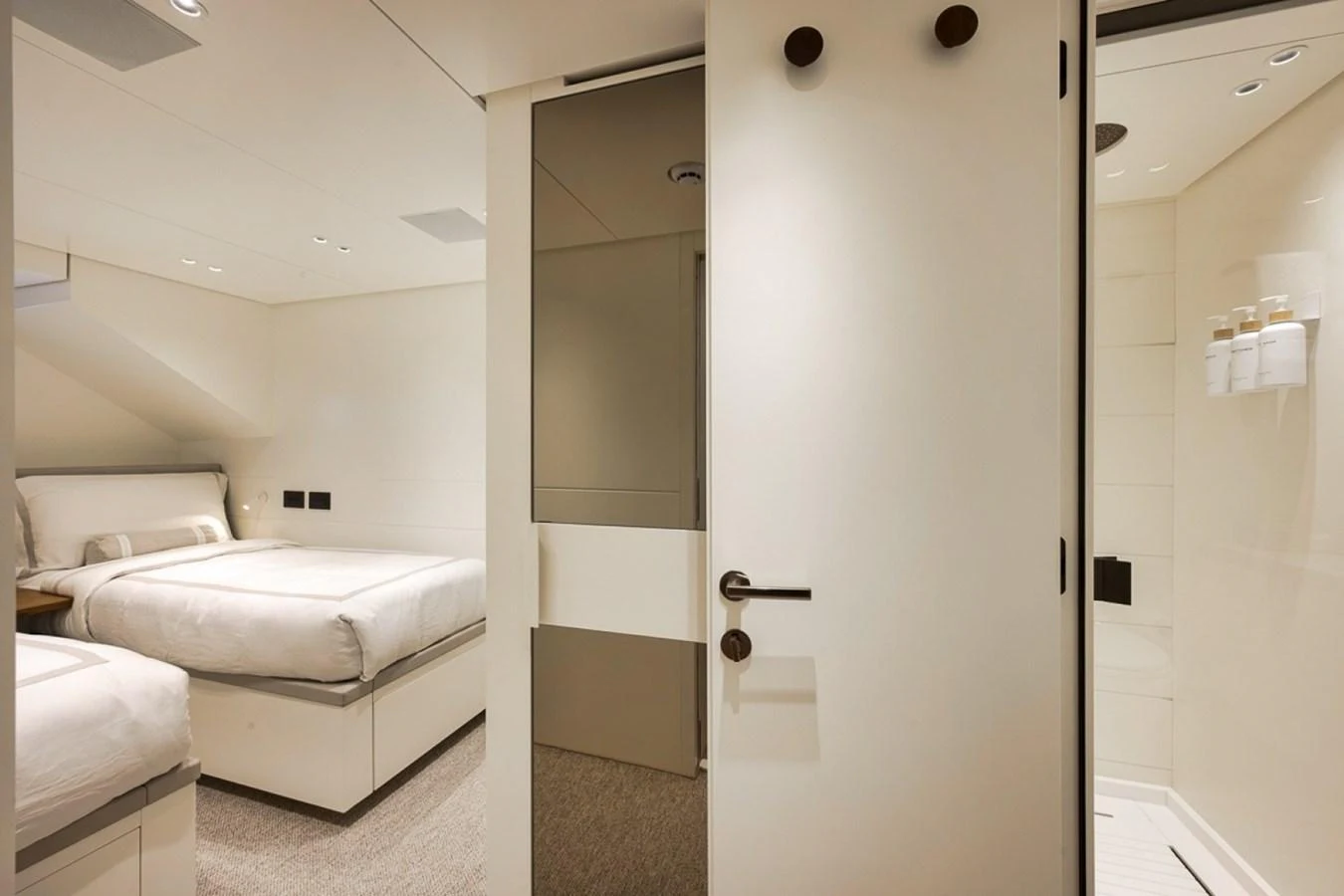 The guest cabin features twin beds and a modern, minimalist design. aboard LAUREN MARIE Yacht for Sale