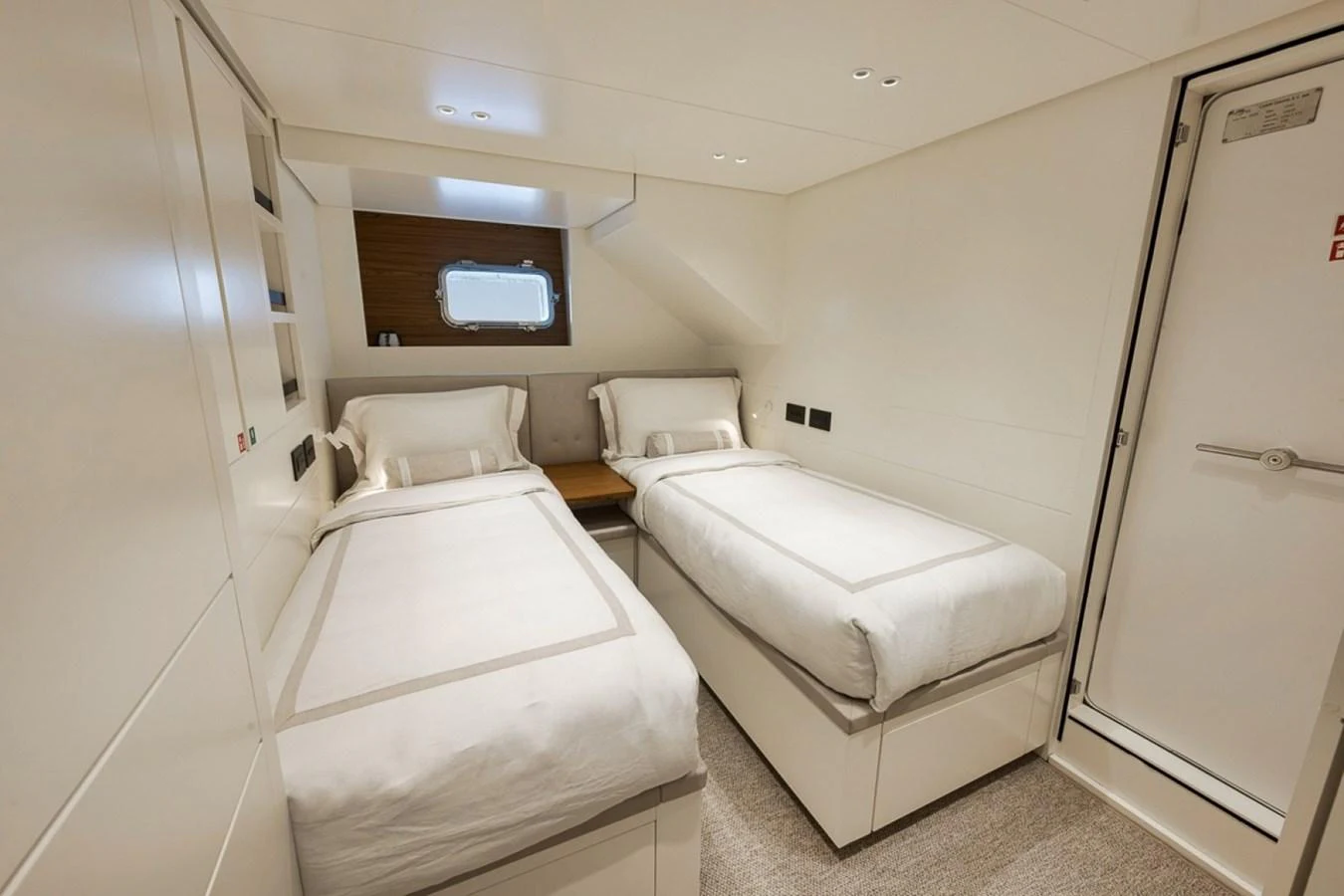 The guest cabin features twin beds with a modern, minimalist design. aboard LAUREN MARIE Yacht for Sale