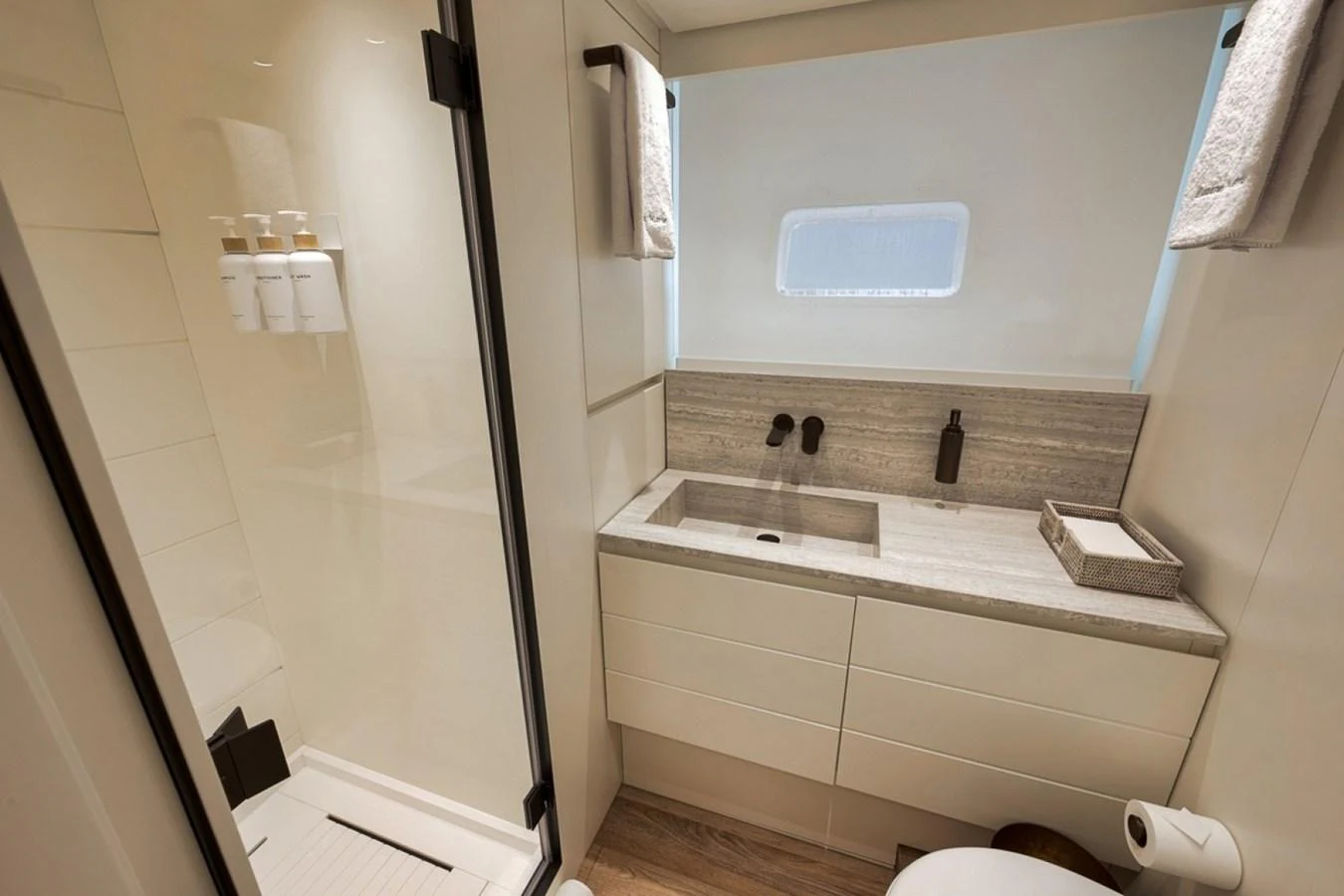 A modern yacht bathroom featuring a sleek shower and elegant vanity. aboard LAUREN MARIE Yacht for Sale