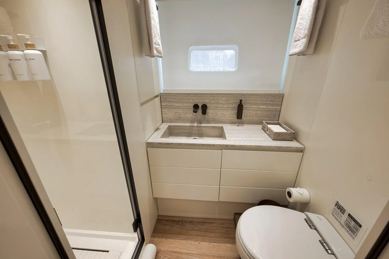 A modern yacht bathroom with sleek fixtures and a minimalist design. aboard LAUREN MARIE Yacht for Sale