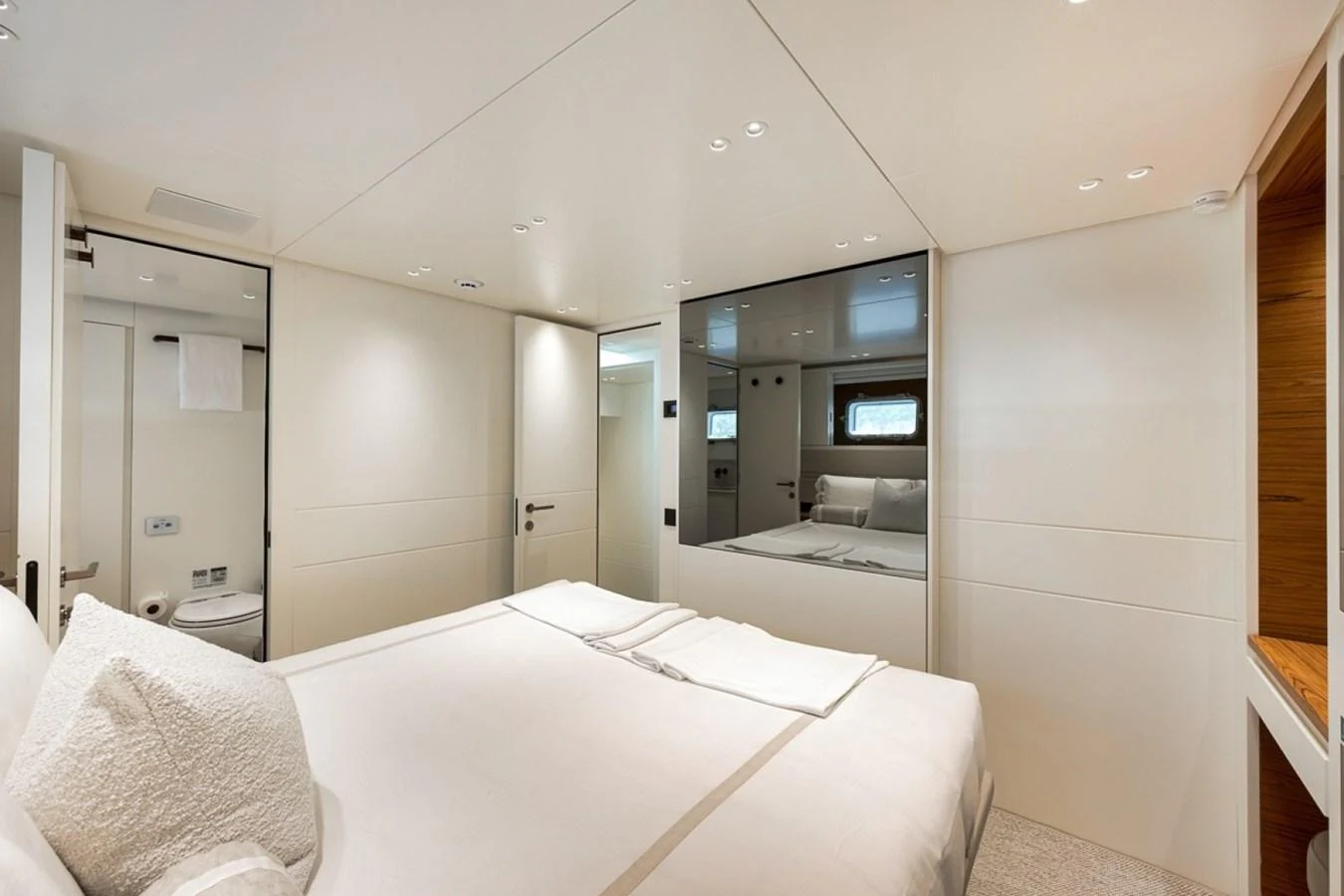 A luxurious stateroom featuring a comfortable bed and modern decor. aboard LAUREN MARIE Yacht for Sale