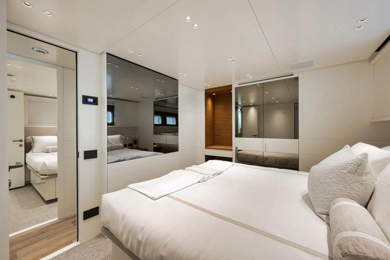 The stateroom features a luxurious bed with elegant bedding and ample natural light. aboard LAUREN MARIE Yacht for Sale