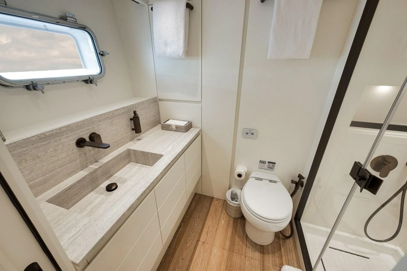 The yacht's bathroom features modern fixtures and a sleek design. aboard LAUREN MARIE Yacht for Sale