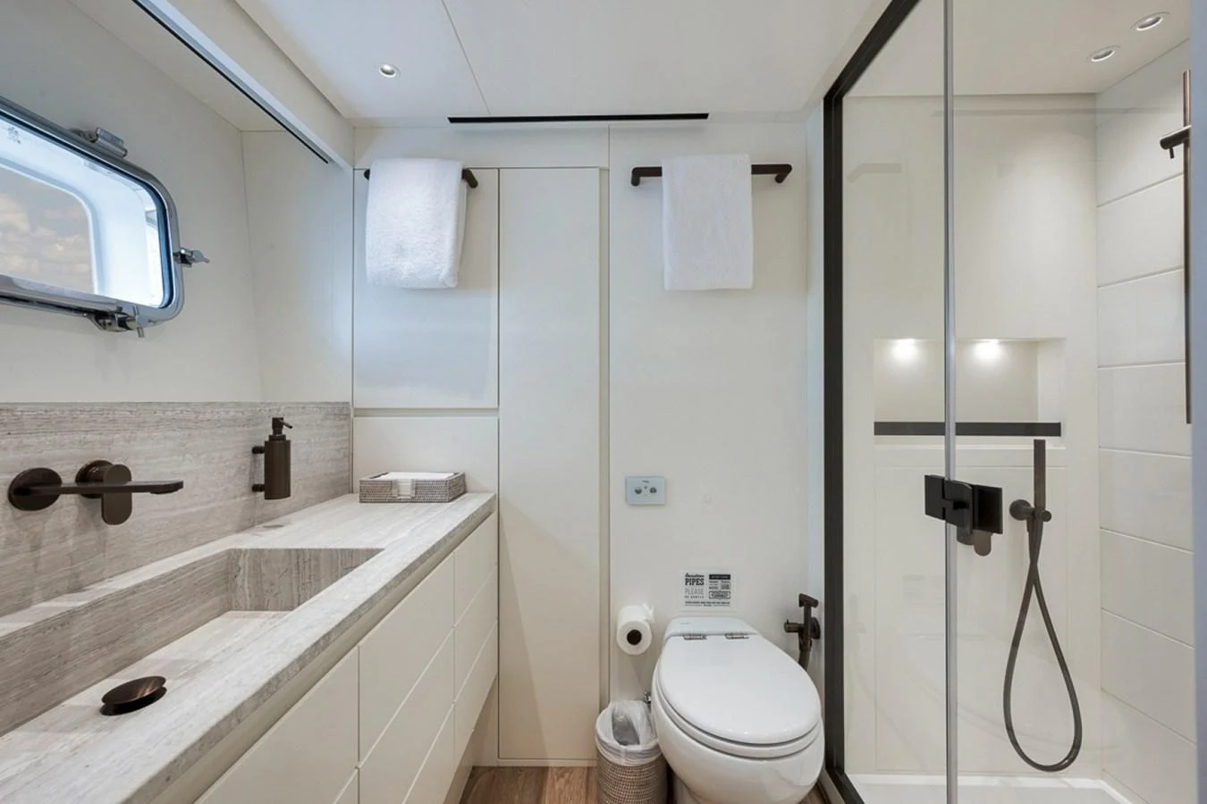 The yacht's bathroom features modern fixtures and a sleek design with ample natural light. aboard LAUREN MARIE Yacht for Sale