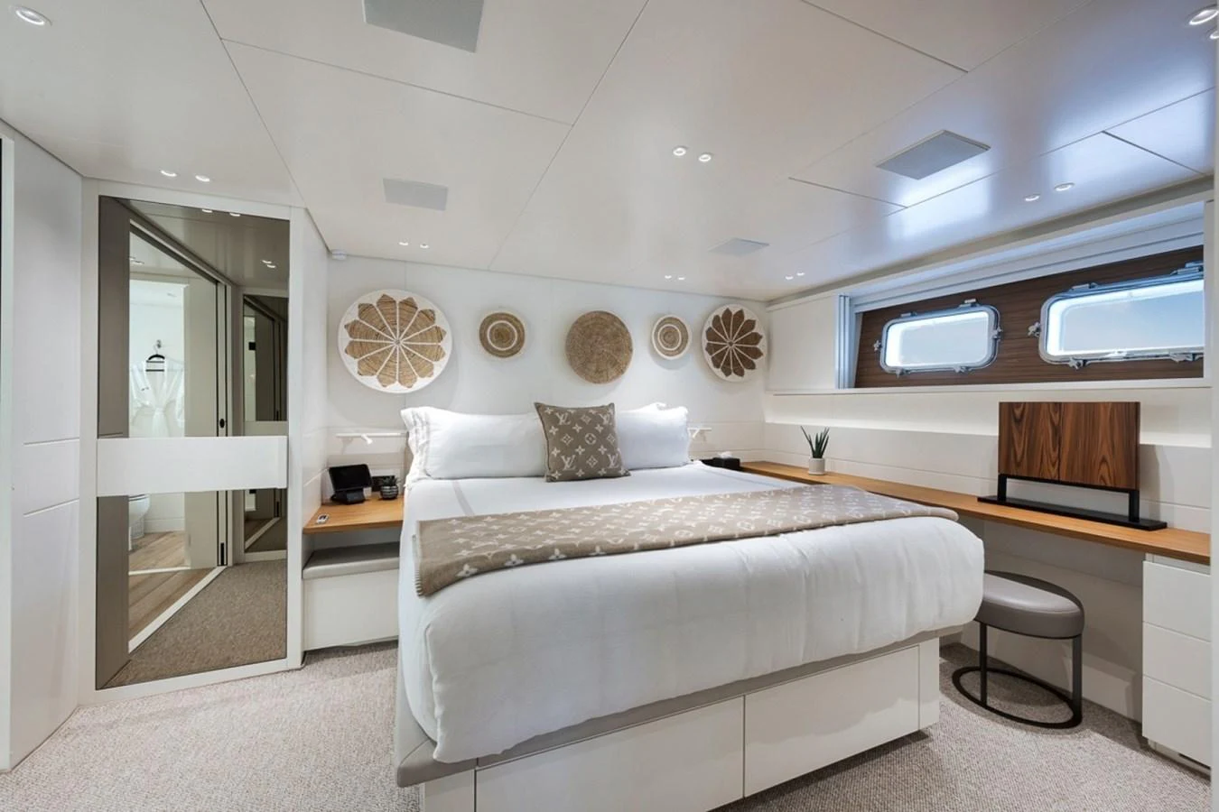 The stateroom features a luxurious bed with elegant decor and ample natural light. aboard LAUREN MARIE Yacht for Sale