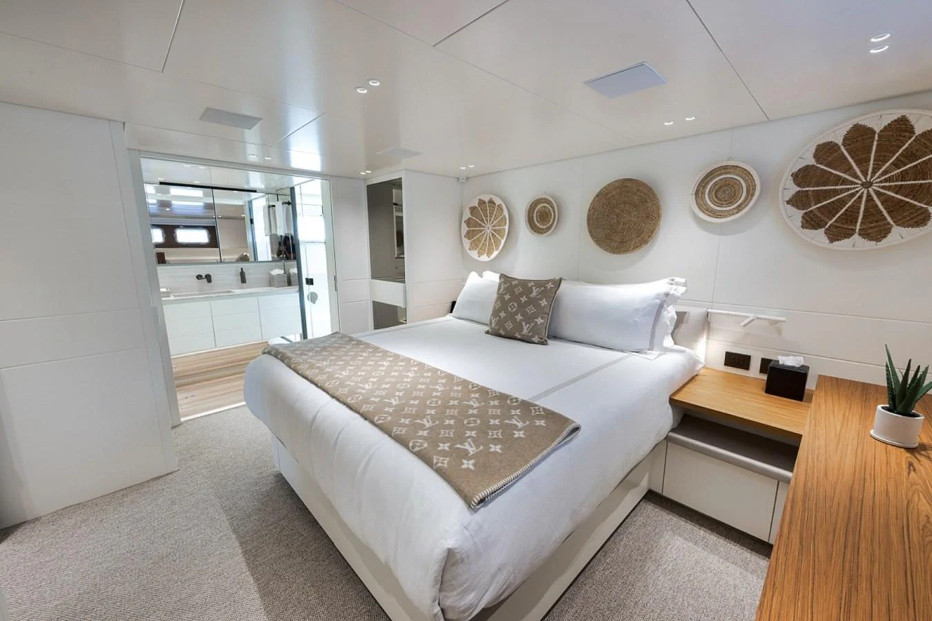 A luxurious stateroom featuring a plush bed, elegant decor, and an en-suite bathroom. aboard LAUREN MARIE Yacht for Sale