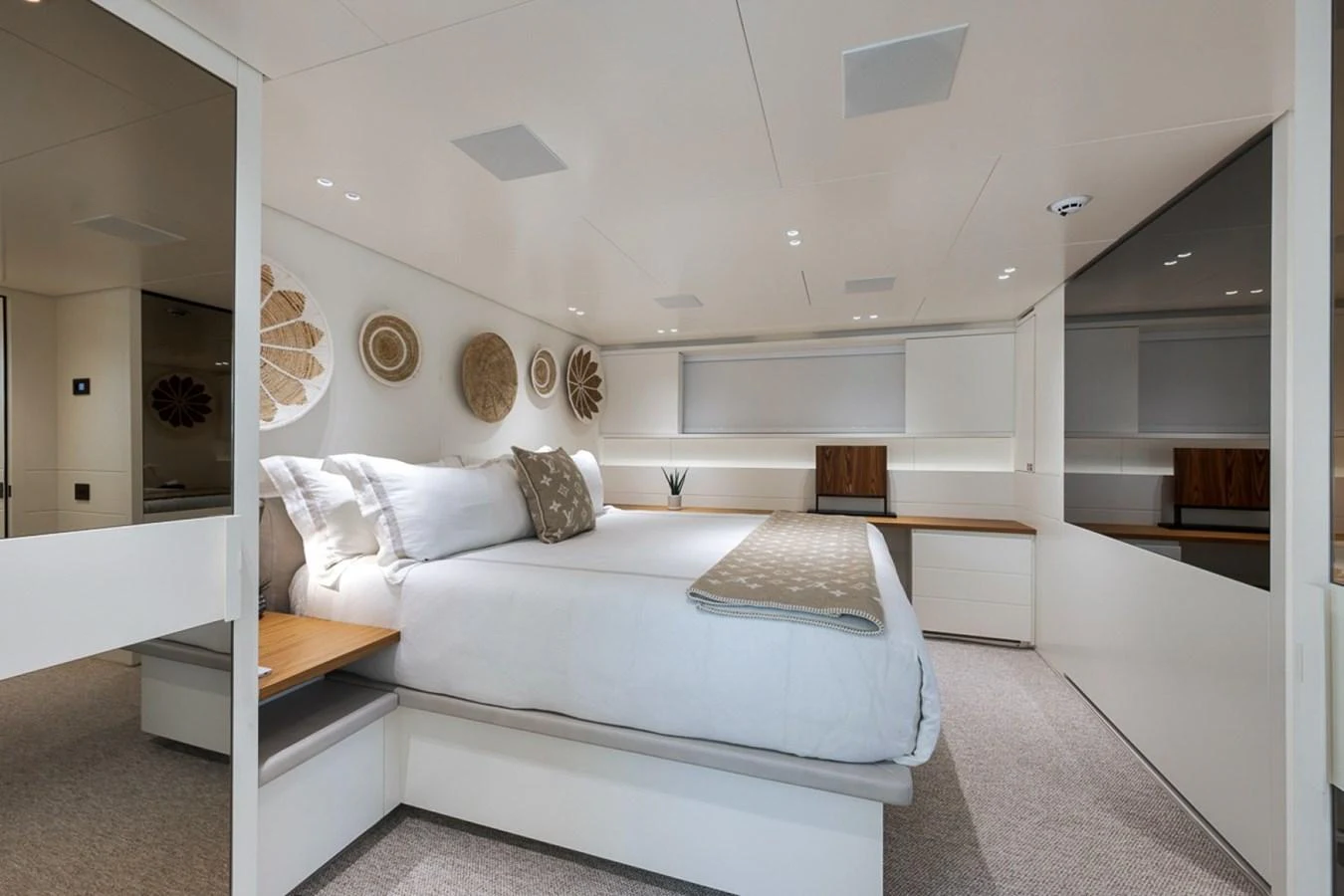 A luxurious stateroom featuring a large bed, modern decor, and ample natural light. aboard LAUREN MARIE Yacht for Sale