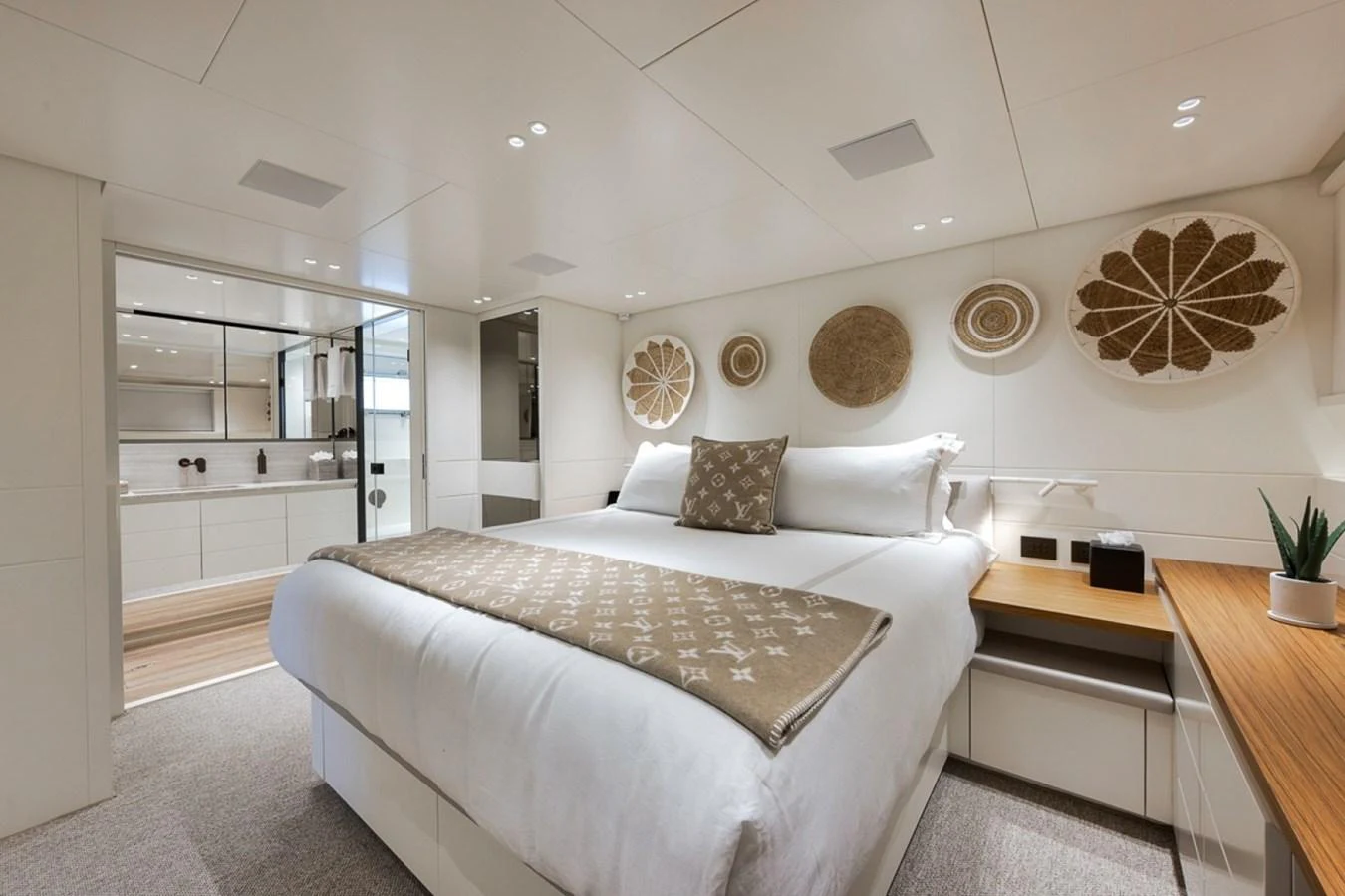 The master stateroom features a luxurious bed with elegant decor and ample natural light. aboard LAUREN MARIE Yacht for Sale