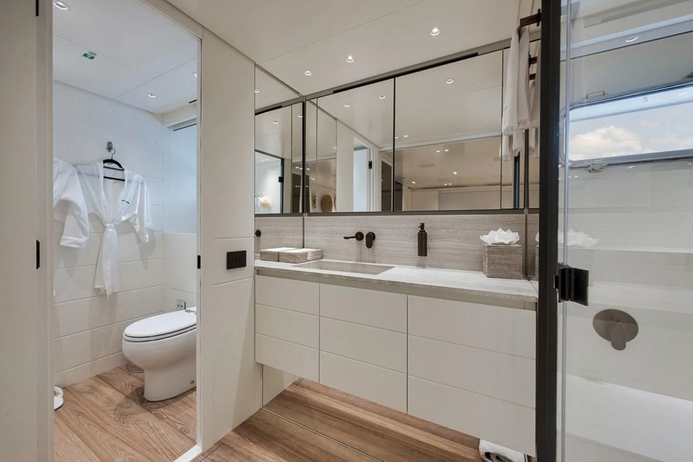 The yacht's bathroom features a sleek, modern design with ample lighting and luxurious amenities. aboard LAUREN MARIE Yacht for Sale