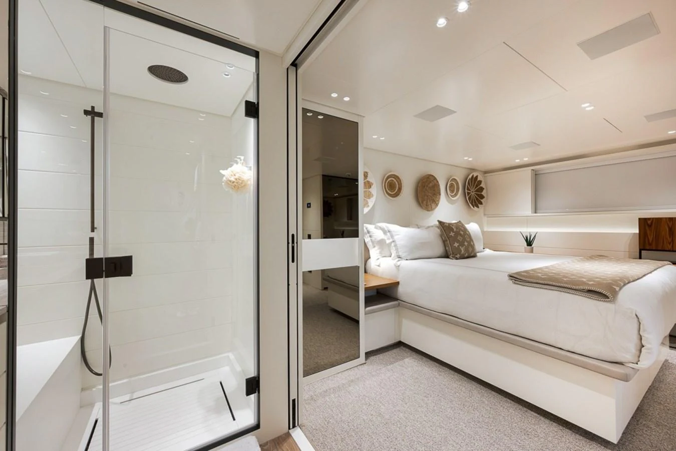 The stateroom features a luxurious bed and an en-suite bathroom with a modern shower. aboard LAUREN MARIE Yacht for Sale