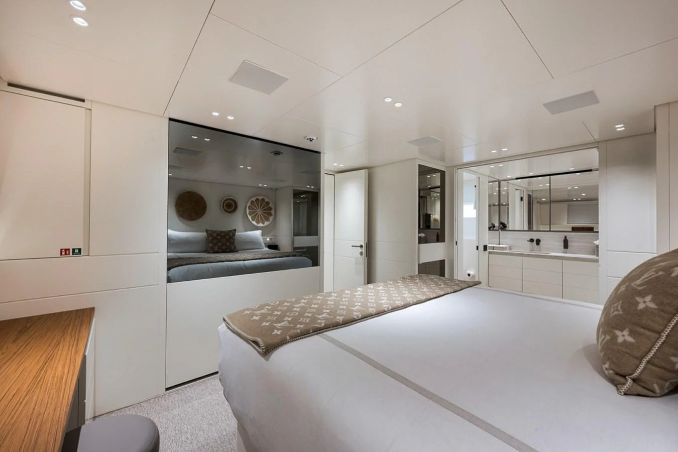 A luxurious stateroom featuring a large bed, modern decor, and ample lighting. aboard LAUREN MARIE Yacht for Sale