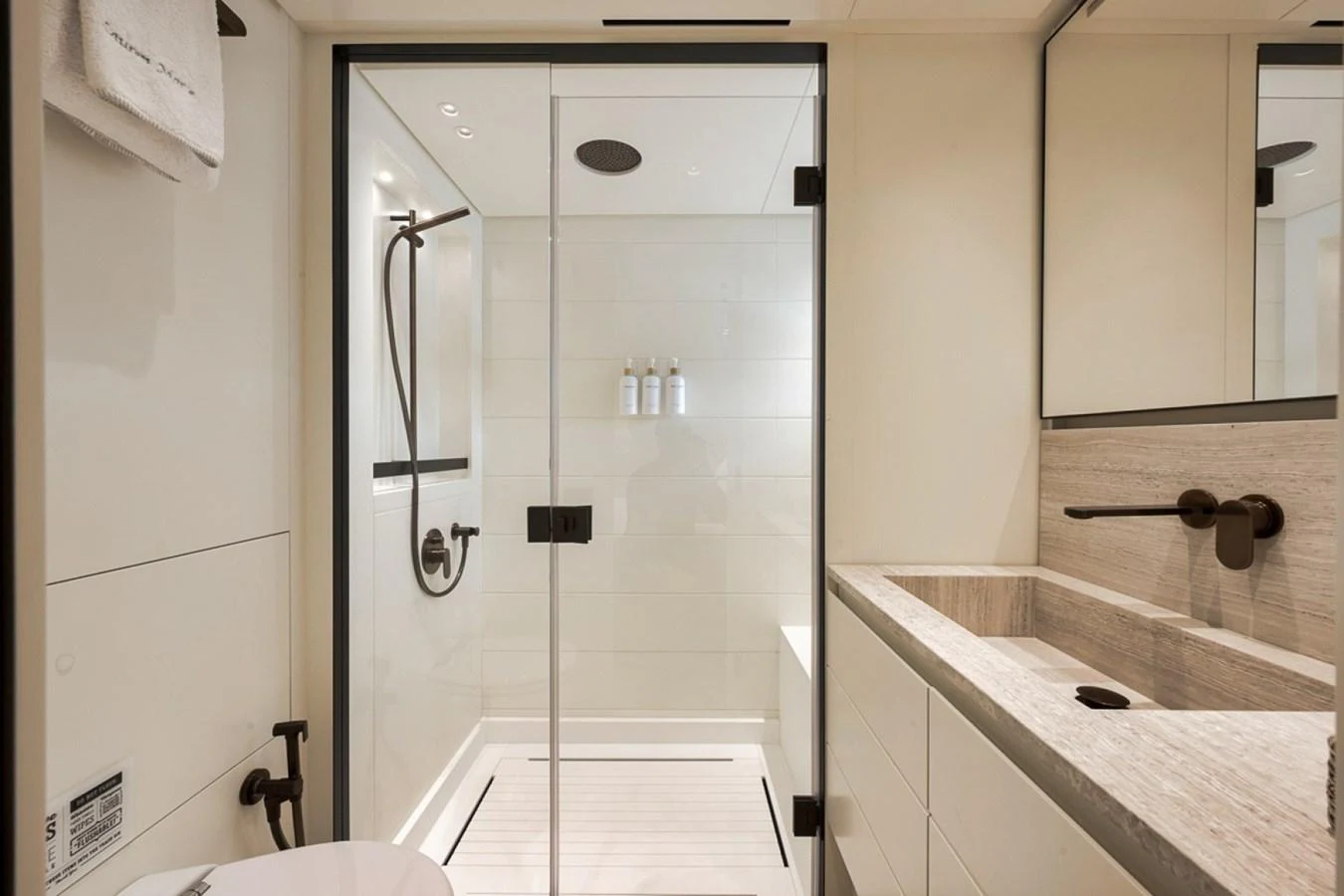 The yacht's bathroom features a sleek, modern design with a spacious shower and elegant fixtures. aboard LAUREN MARIE Yacht for Sale