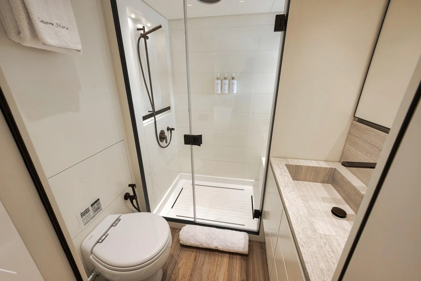 A modern yacht bathroom with a glass-enclosed shower and sleek fixtures. aboard LAUREN MARIE Yacht for Sale