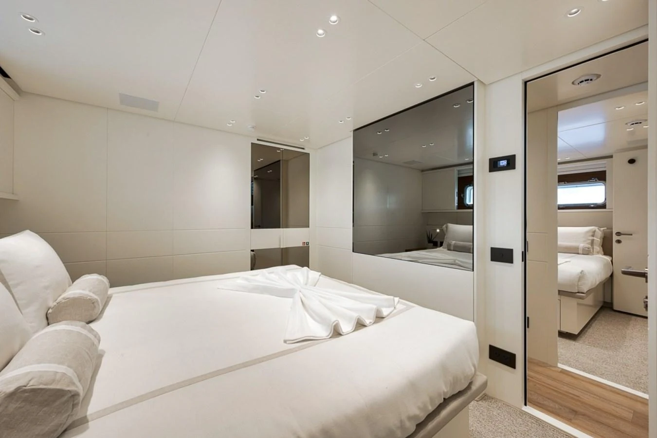 The stateroom features a luxurious bed with elegant linens and modern decor. aboard LAUREN MARIE Yacht for Sale