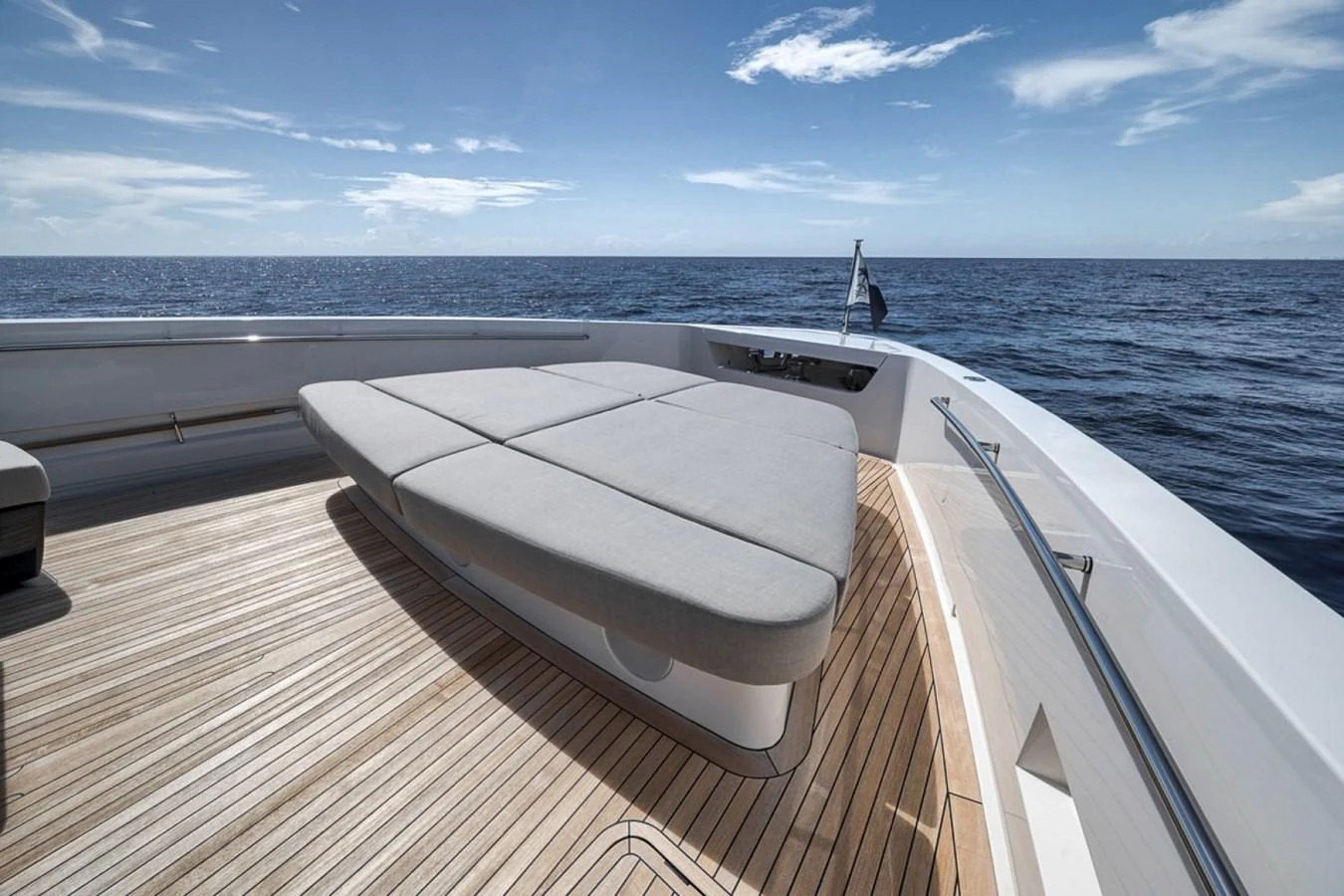 The yacht's foredeck features a spacious sunbathing area with plush cushions and stunning ocean views. aboard LAUREN MARIE Yacht for Sale