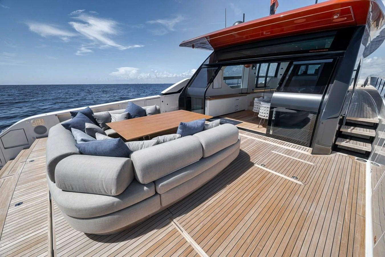 The aft deck features a spacious lounging area with plush seating and a wooden table, perfect for relaxing and enjoying the ocean view. aboard LAUREN MARIE Yacht for Sale