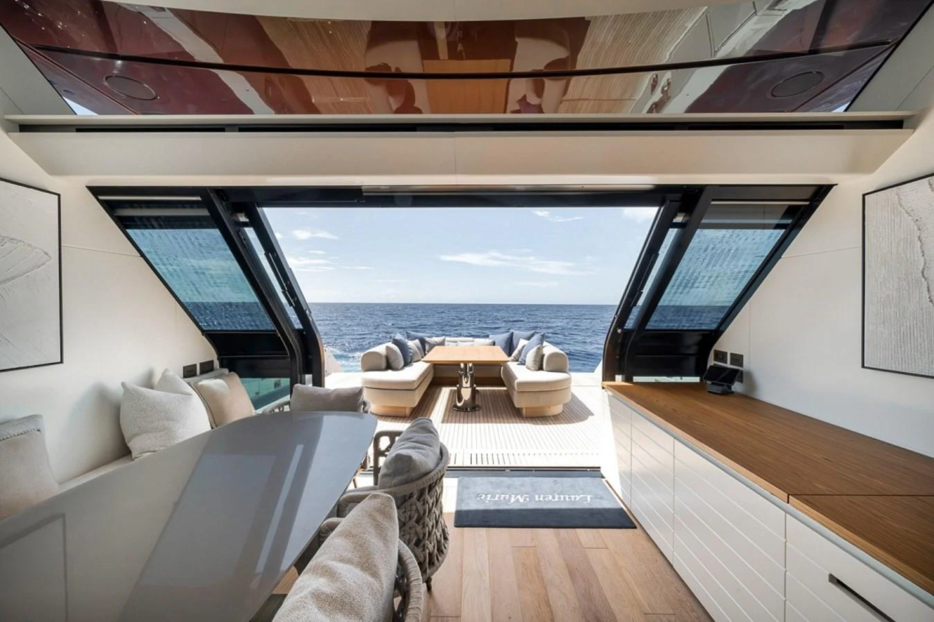The salon offers a seamless transition to the aft deck with expansive ocean views. aboard LAUREN MARIE Yacht for Sale