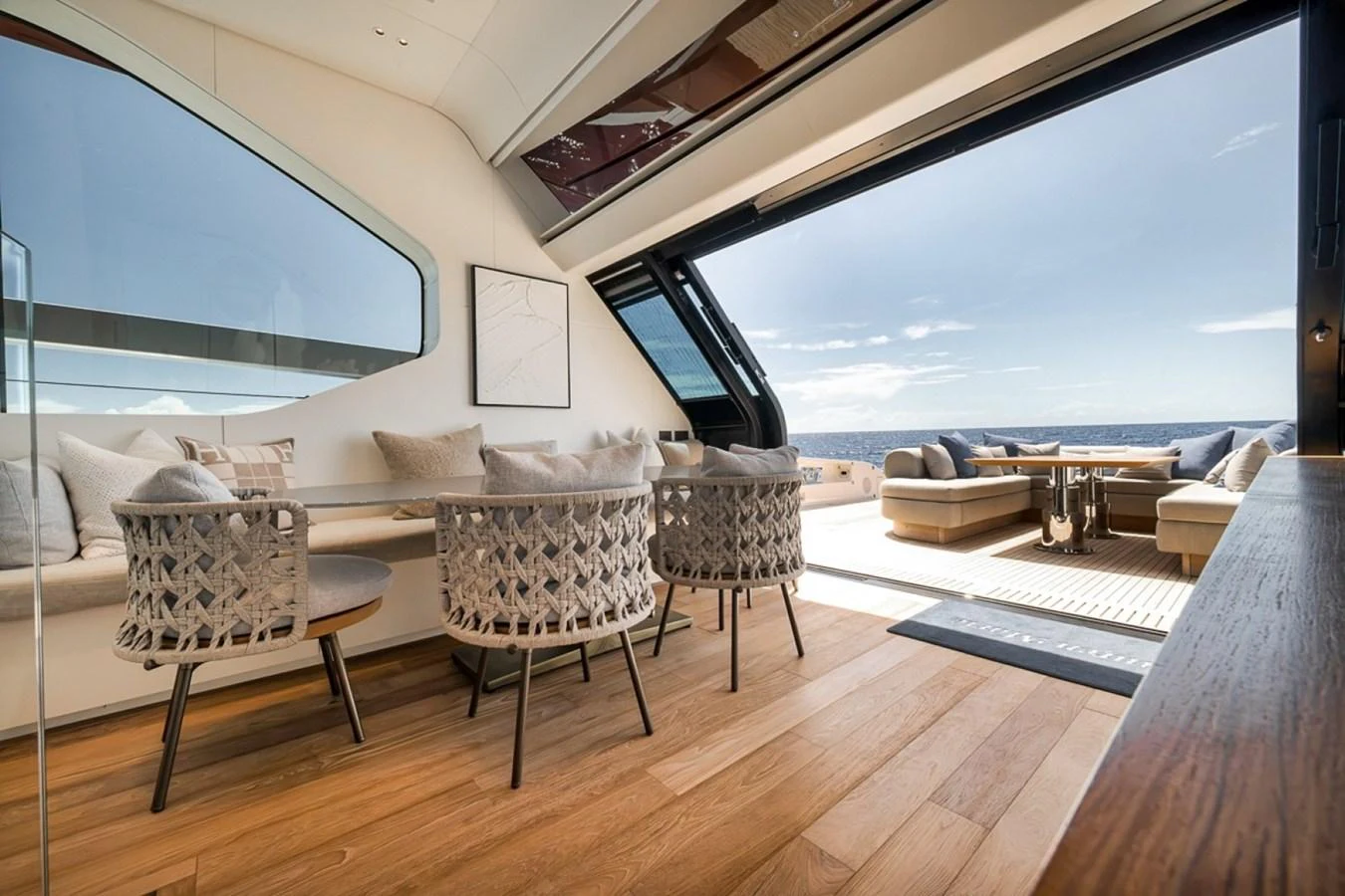 The salon features a stylish dining area with a seamless transition to the outdoor deck, offering stunning ocean views. aboard LAUREN MARIE Yacht for Sale
