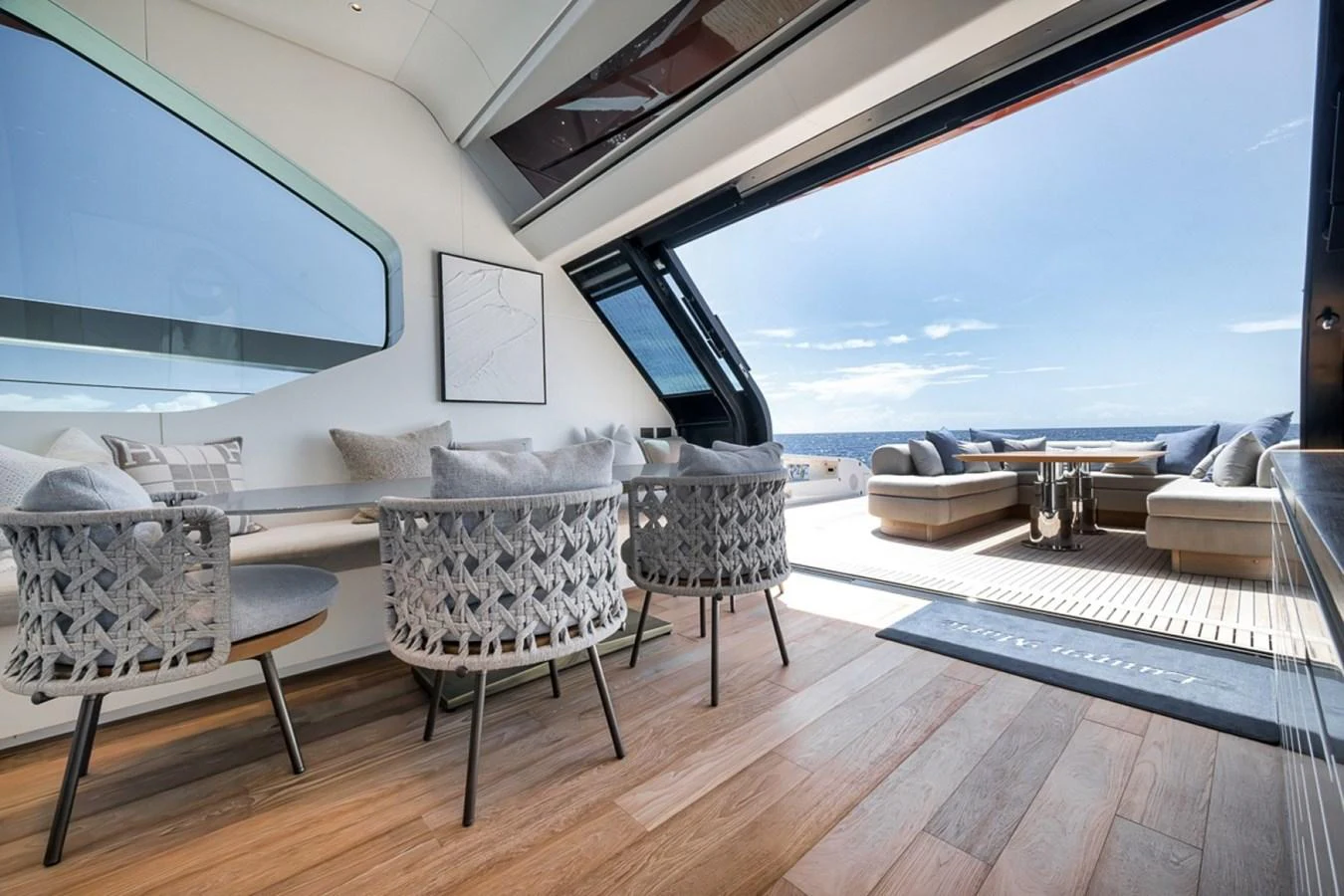 The salon offers a seamless transition to the outdoor seating area, featuring modern furnishings and expansive views. aboard LAUREN MARIE Yacht for Sale