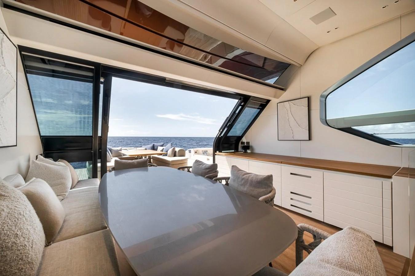 The yacht's dining area offers a luxurious and spacious setting with panoramic ocean views. aboard LAUREN MARIE Yacht for Sale