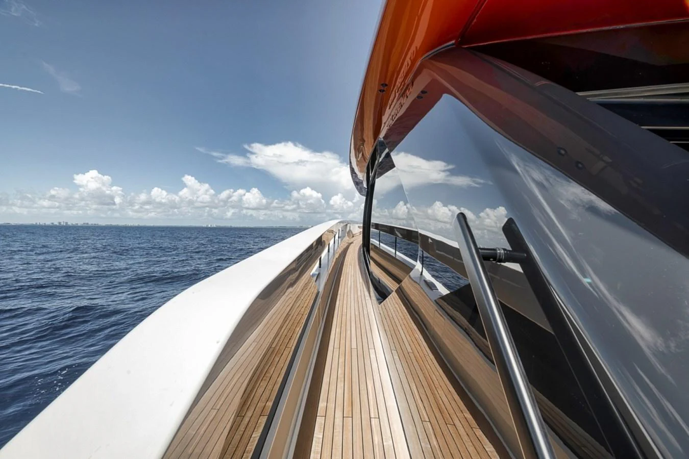 The sleek exterior walkway of the yacht showcases modern design and craftsmanship against a serene ocean backdrop. aboard LAUREN MARIE Yacht for Sale