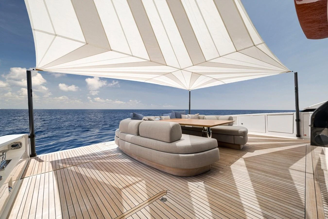 The aft deck features luxurious seating under a stylish canopy, offering a perfect spot to relax and enjoy the ocean view. aboard LAUREN MARIE Yacht for Sale