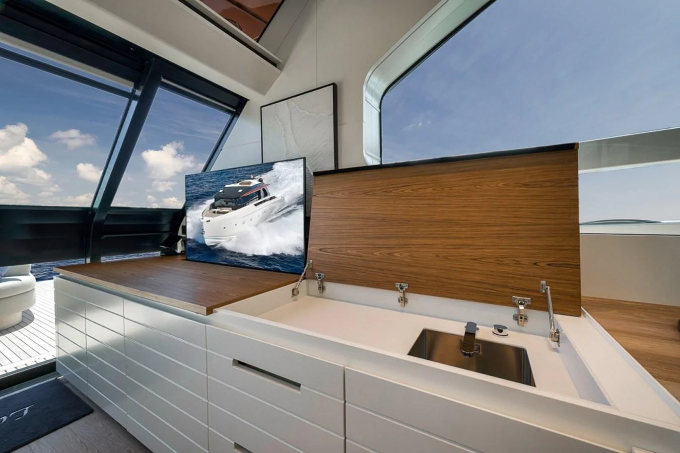 The galley features sleek cabinetry, a modern sink, and a large window offering stunning ocean views. aboard LAUREN MARIE Yacht for Sale