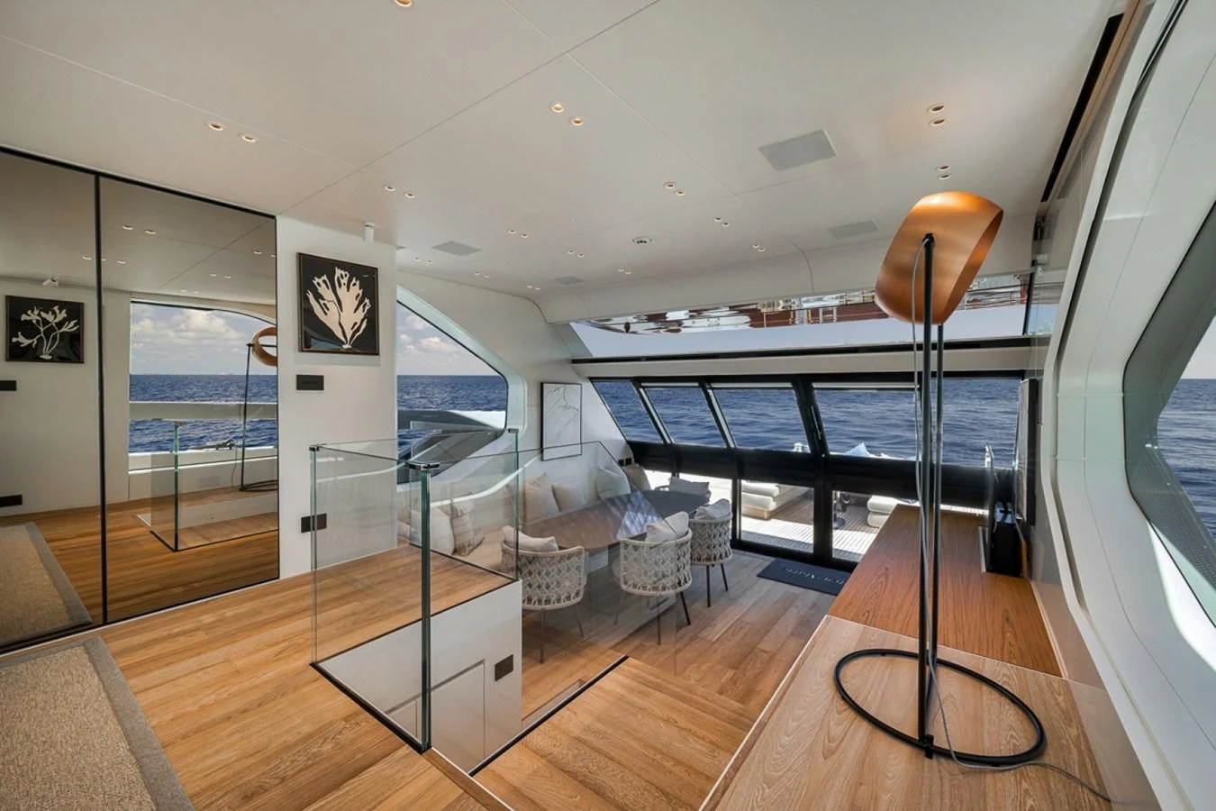 The yacht's interior features a spacious and modern living area with large windows offering stunning ocean views. aboard LAUREN MARIE Yacht for Sale