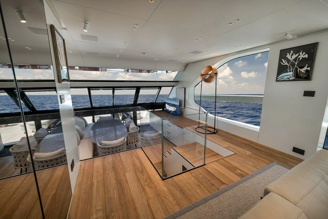 The salon features expansive windows offering stunning ocean views and modern furnishings. aboard LAUREN MARIE Yacht for Sale