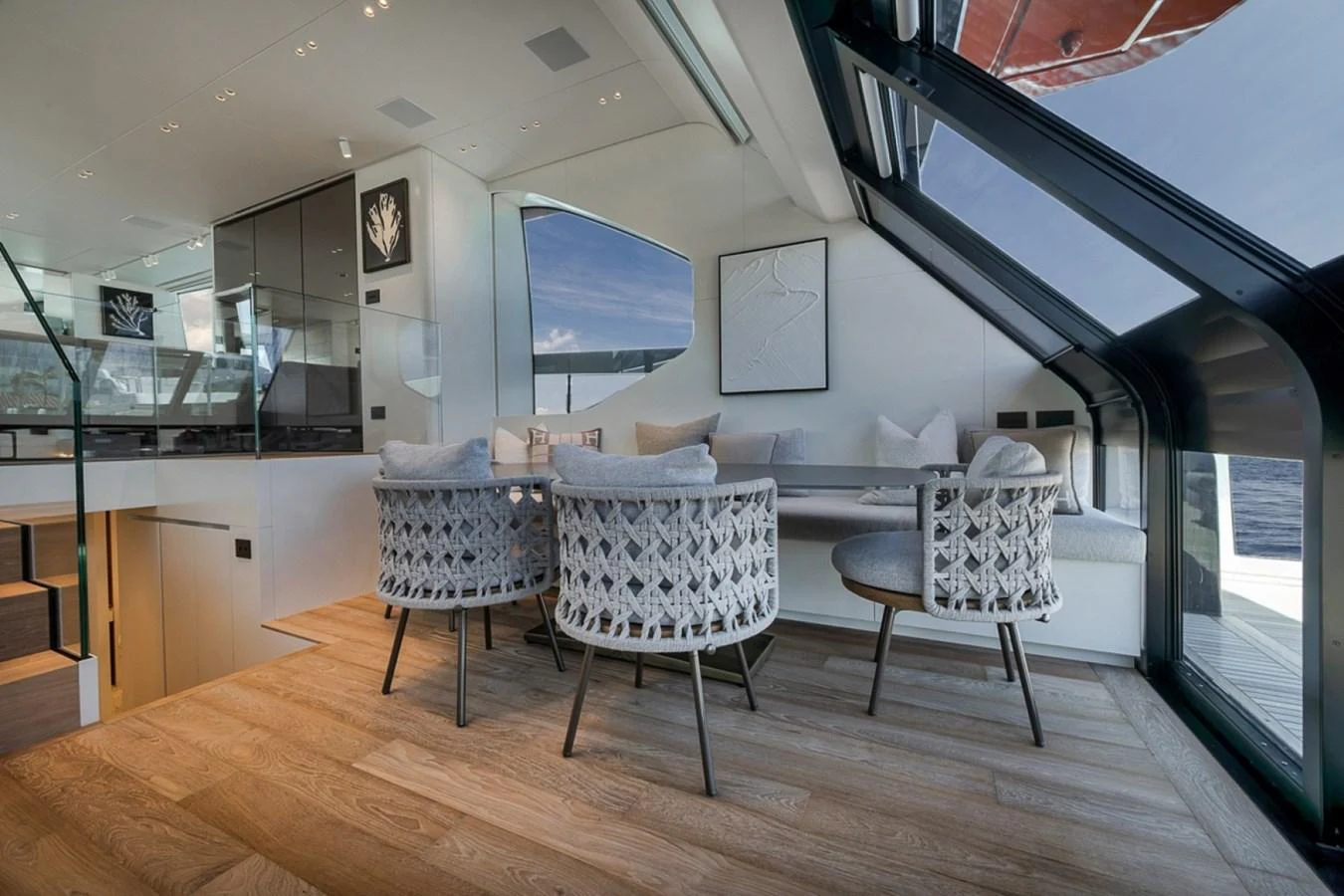 The yacht's dining area features modern furnishings and expansive windows for a luxurious dining experience with stunning views. aboard LAUREN MARIE Yacht for Sale