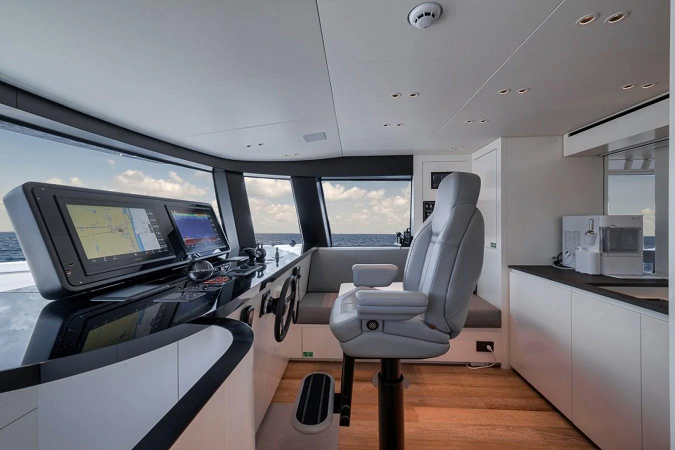 The helm station features advanced navigation equipment and a comfortable captain's chair, offering panoramic views. aboard LAUREN MARIE Yacht for Sale