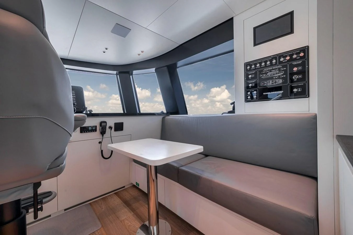 The helm area features a sleek, modern design with a comfortable seating arrangement and advanced control panels. aboard LAUREN MARIE Yacht for Sale