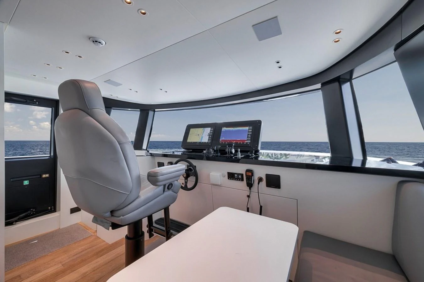 The helm station offers a commanding view with state-of-the-art navigation equipment and luxurious seating. aboard LAUREN MARIE Yacht for Sale