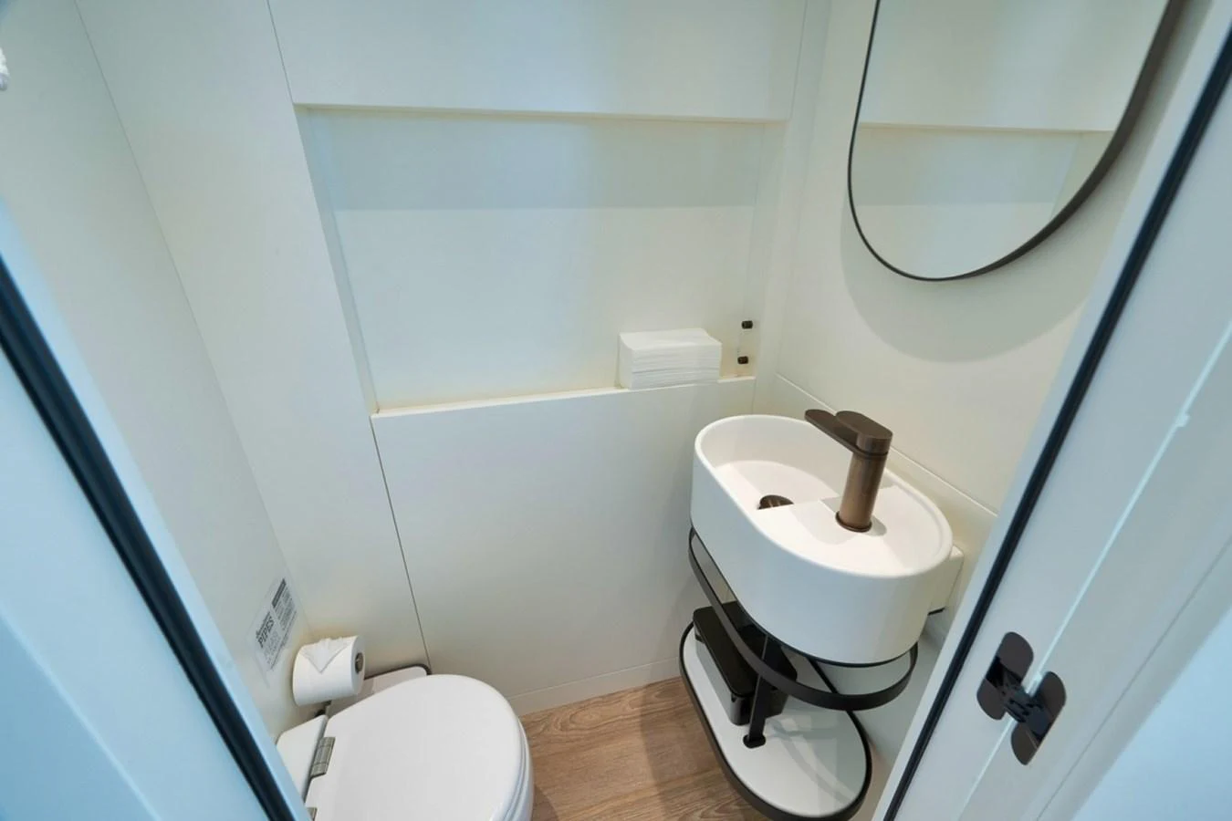 A compact and modern yacht bathroom featuring a sleek sink and toilet. aboard LAUREN MARIE Yacht for Sale