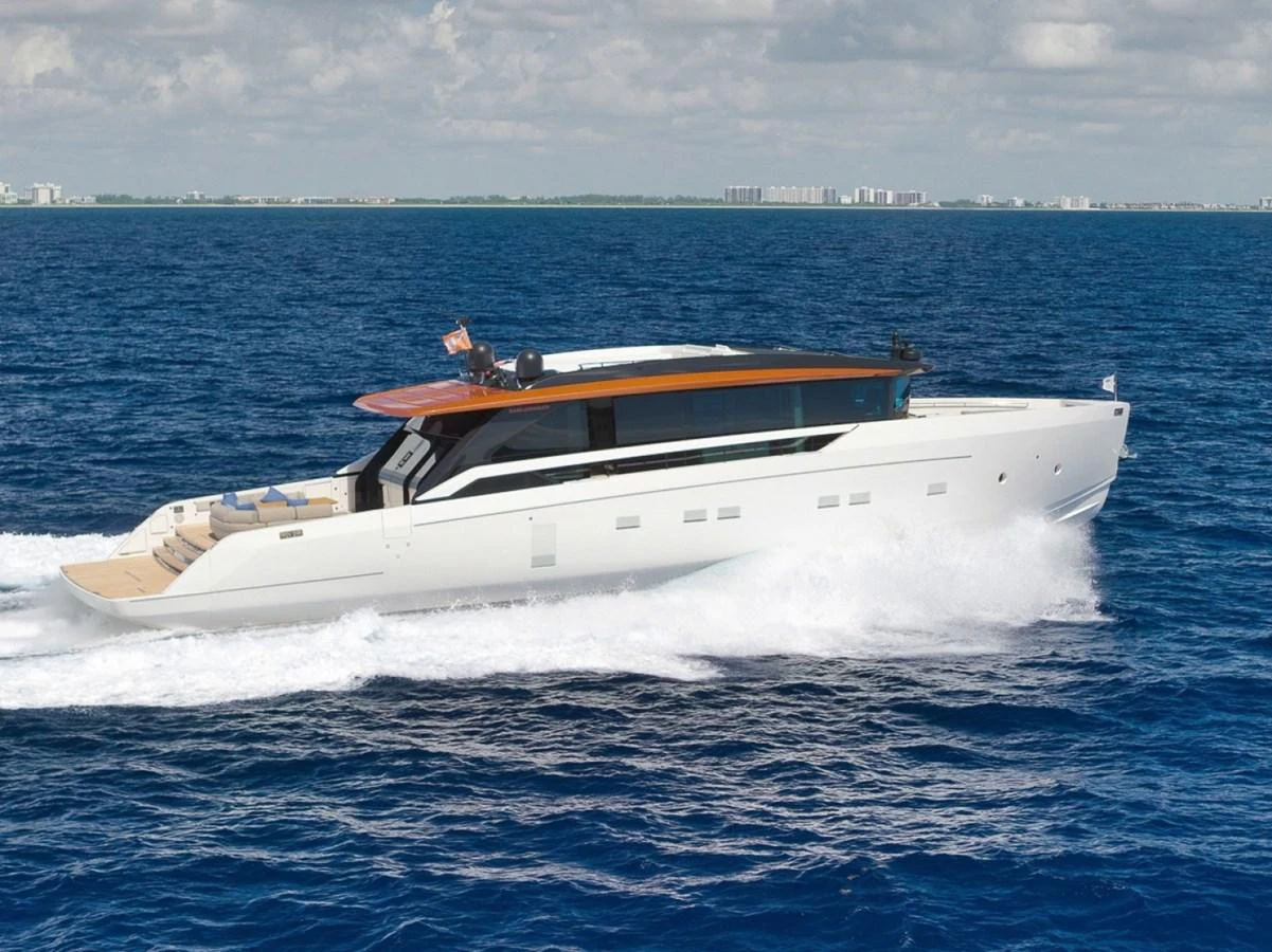 A sleek, modern yacht cruises swiftly through the open sea under a partly cloudy sky. aboard LAUREN MARIE Yacht for Sale