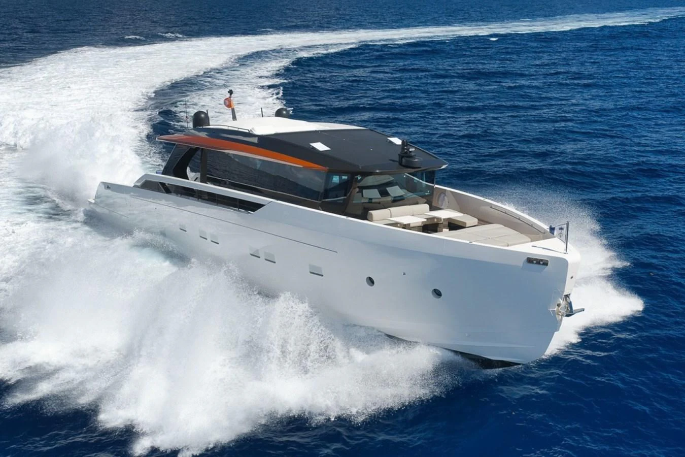 A sleek, modern yacht cuts through the water at high speed, showcasing its impressive design and performance. aboard LAUREN MARIE Yacht for Sale