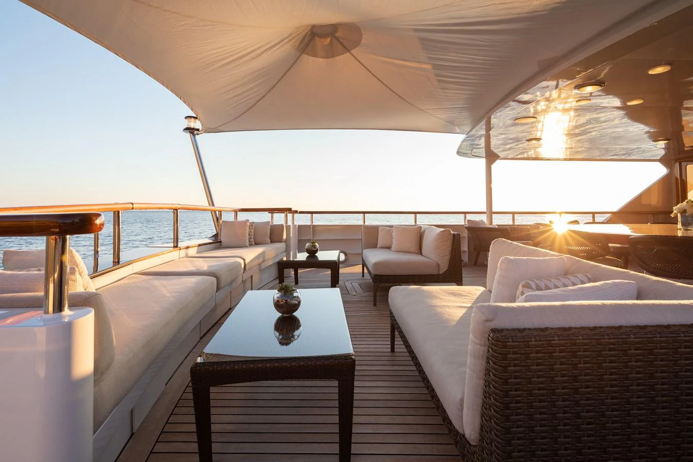 The aft deck offers a luxurious outdoor seating area with comfortable sofas and a shaded canopy. aboard MIRAGE Yacht for Sale