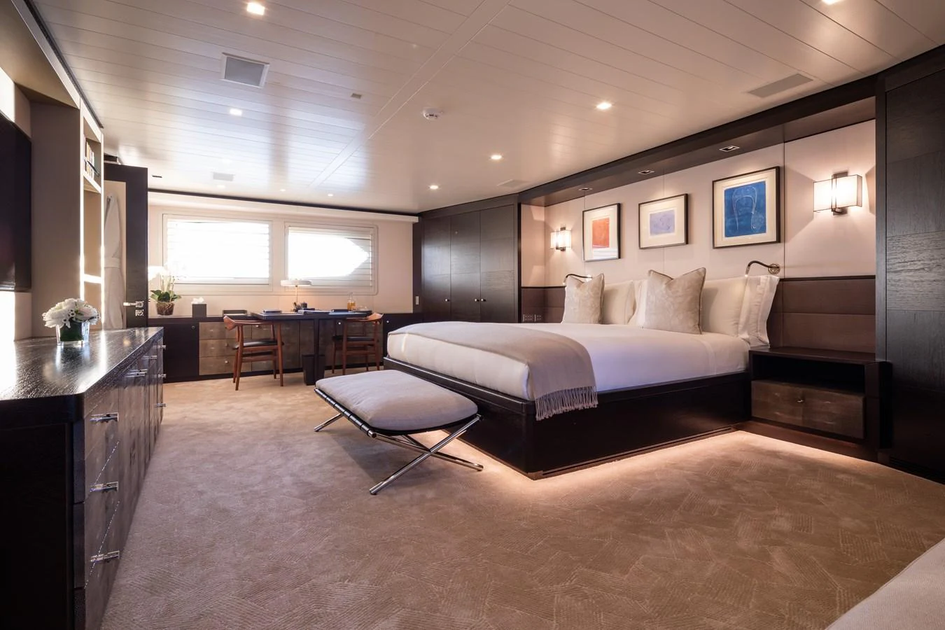 The master stateroom features a luxurious bed and elegant furnishings. aboard MIRAGE Yacht for Sale