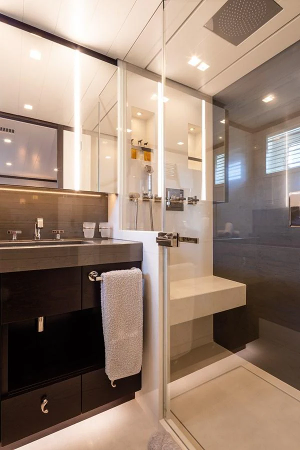 A modern yacht bathroom featuring a sleek shower and vanity area. aboard MIRAGE Yacht for Sale