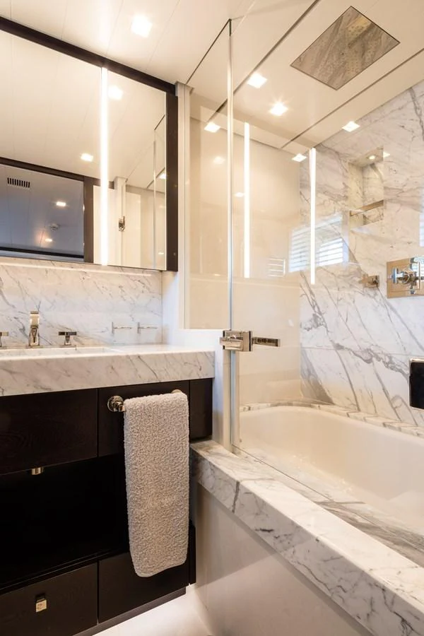 The yacht's bathroom features elegant marble surfaces and modern fixtures. aboard MIRAGE Yacht for Sale