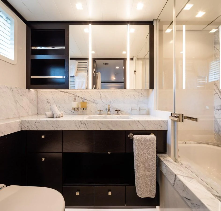 The yacht's bathroom features elegant marble countertops and modern fixtures. aboard MIRAGE Yacht for Sale