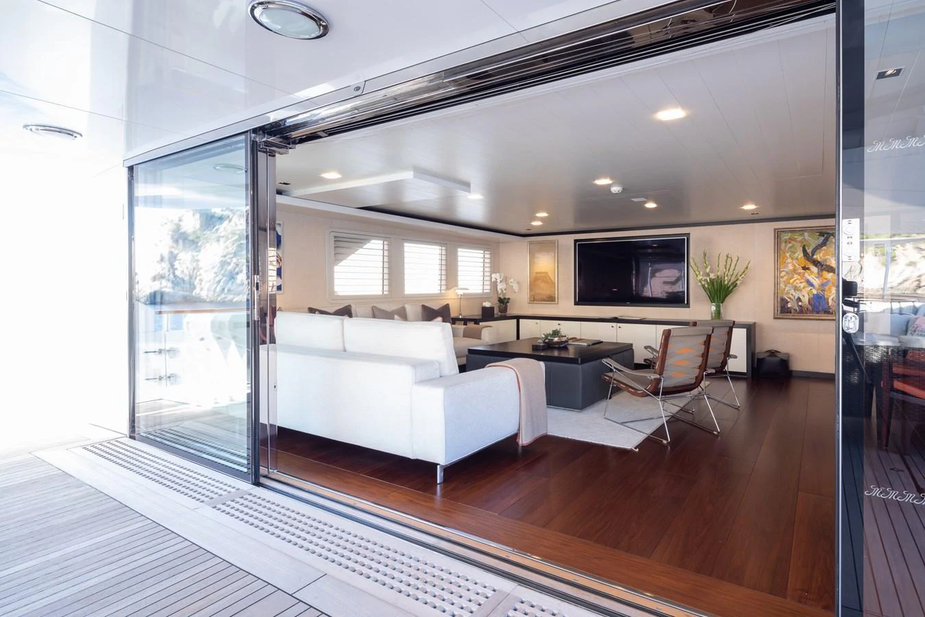 The yacht's salon features elegant seating and modern decor, creating a comfortable and stylish living area. aboard MIRAGE Yacht for Sale