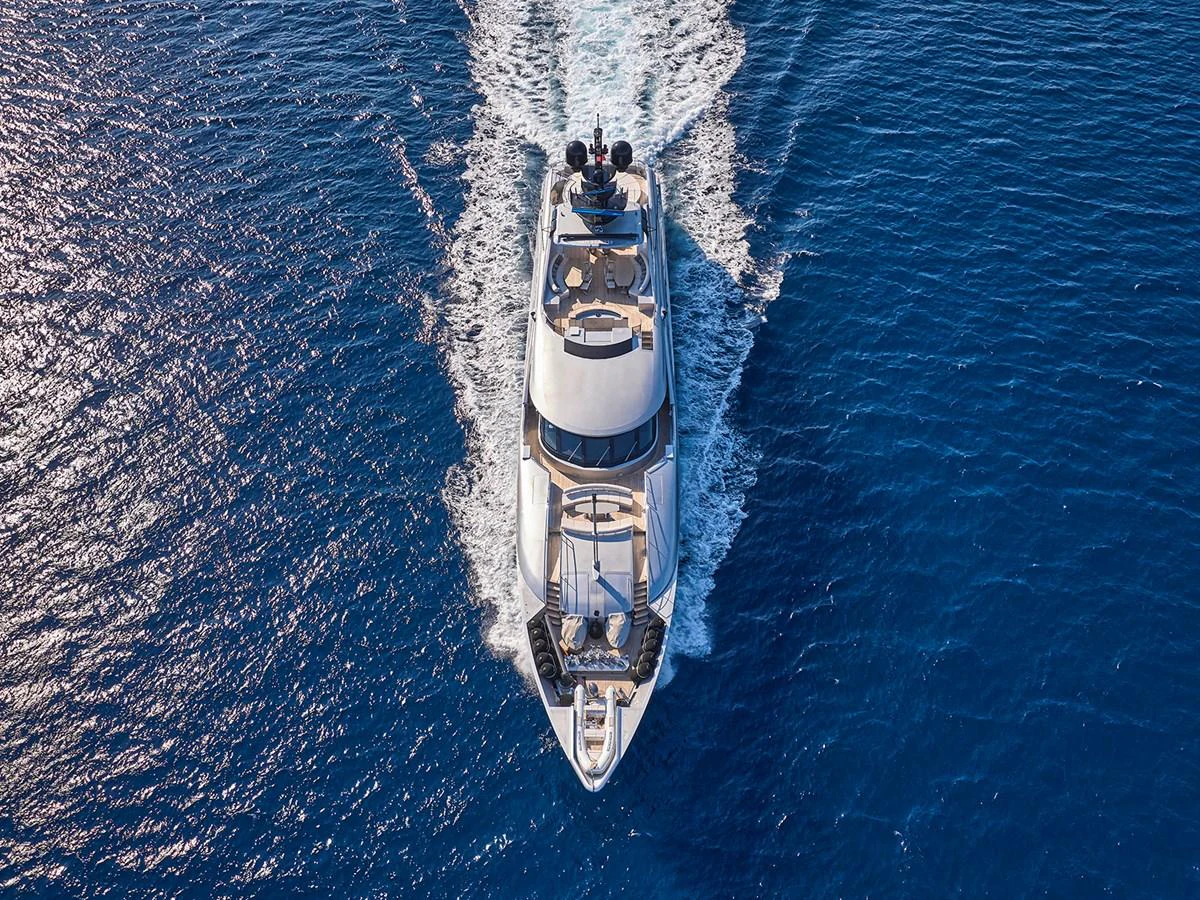 A stunning aerial view of a yacht cruising through the deep blue sea. aboard BELITA Yacht for Sale