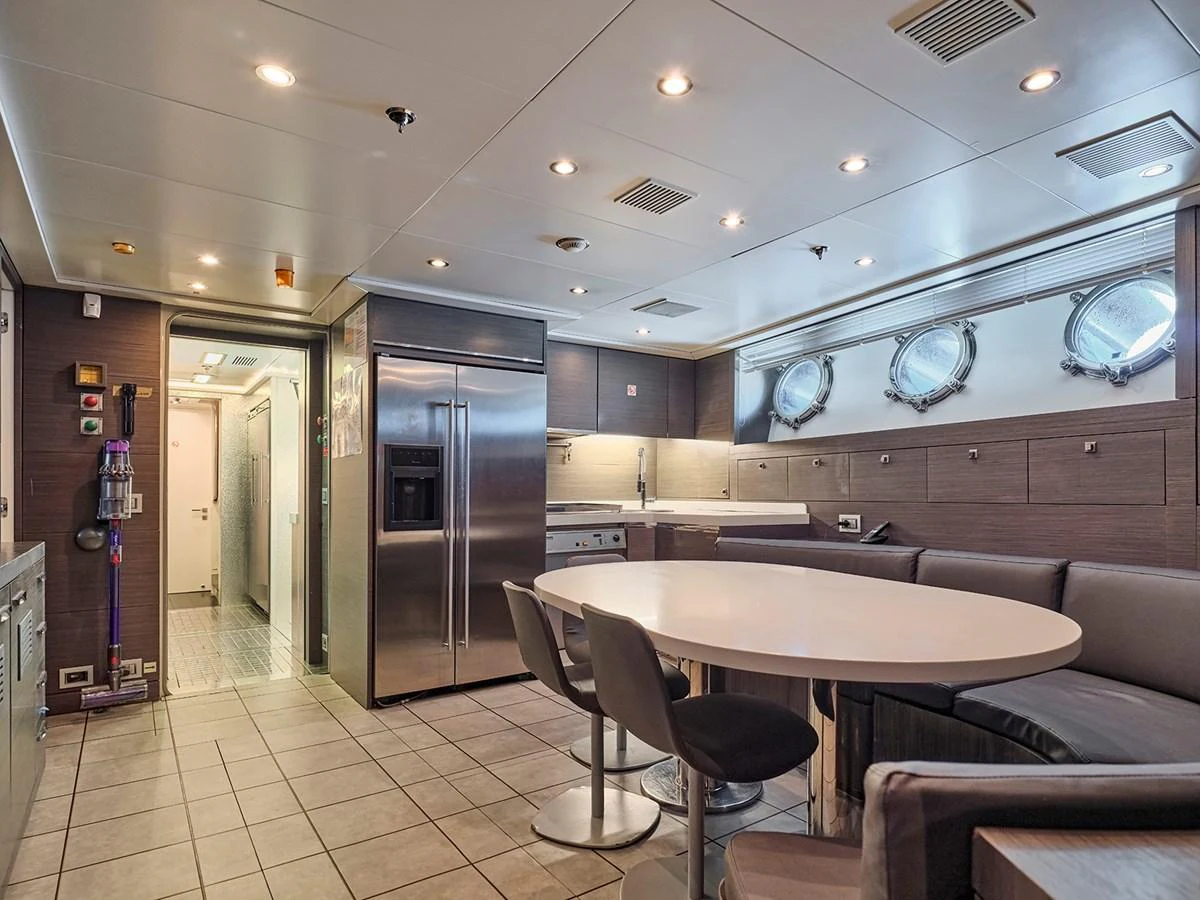 The galley features modern appliances and a spacious dining area with ample seating. aboard BELITA Yacht for Sale