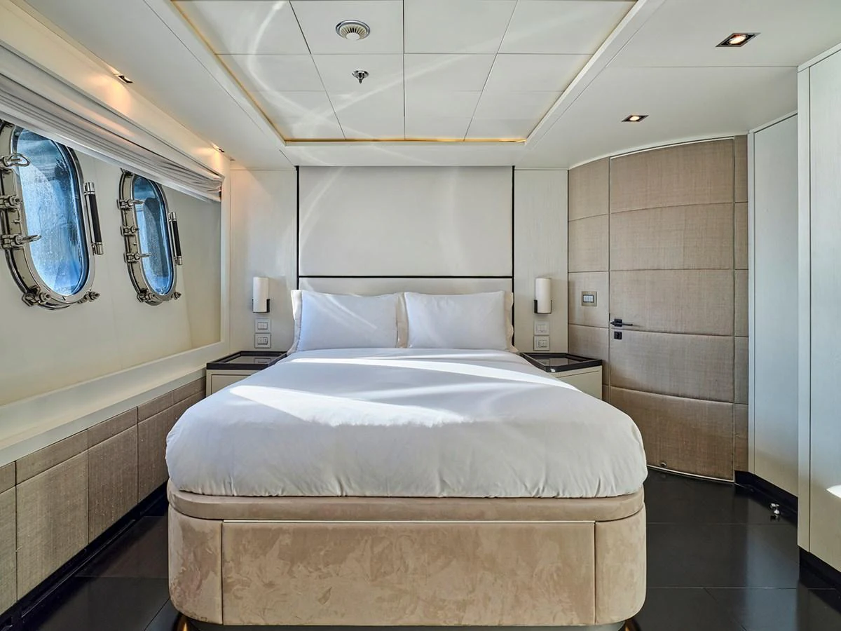 A luxurious stateroom featuring a plush bed and elegant decor. aboard BELITA Yacht for Sale