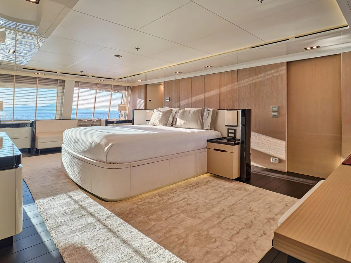 The master stateroom features a luxurious bed and elegant furnishings with ample natural light. aboard BELITA Yacht for Sale