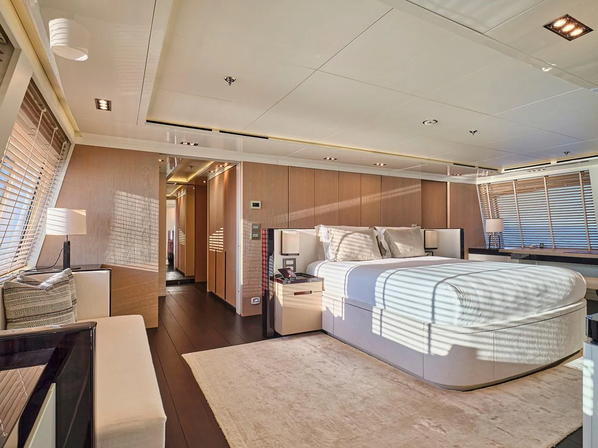 The master stateroom features a spacious bed, elegant decor, and ample natural light. aboard BELITA Yacht for Sale