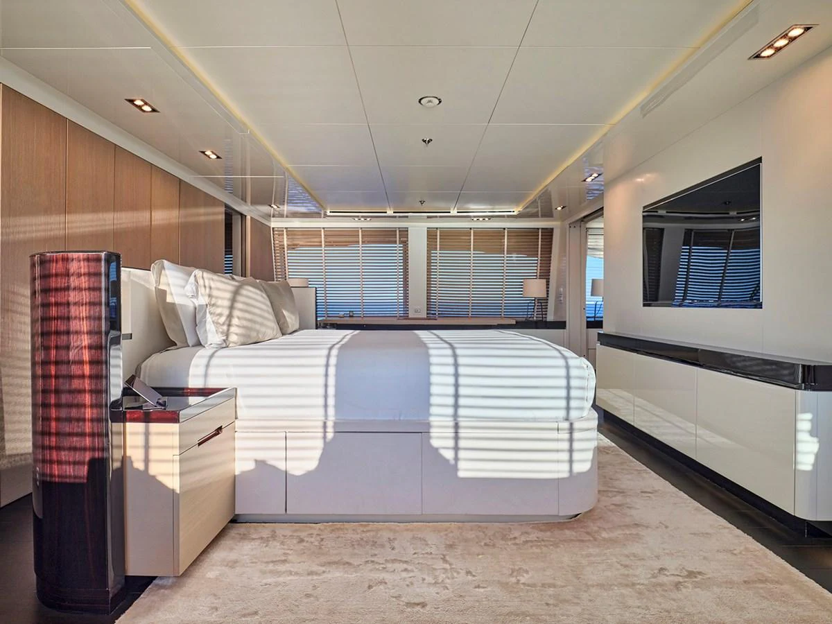 The master stateroom features a spacious bed, modern furnishings, and ample natural light. aboard BELITA Yacht for Sale