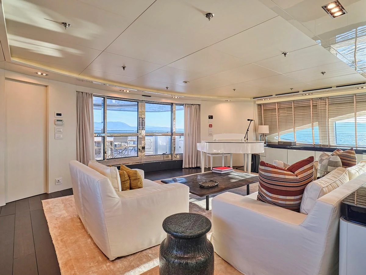 The yacht's interior features a spacious and elegantly furnished living area with large windows offering stunning views. aboard BELITA Yacht for Sale