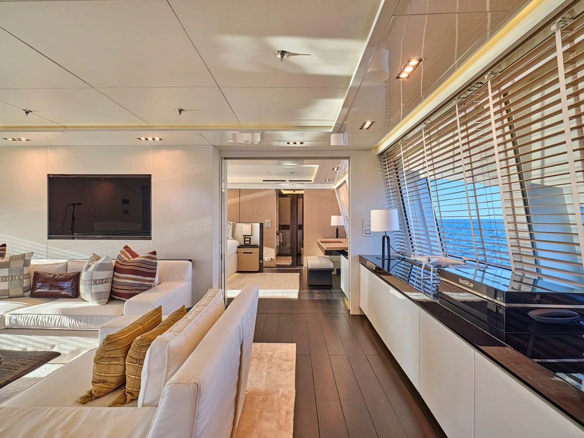The yacht's salon features luxurious seating, modern decor, and ample natural light through large windows. aboard BELITA Yacht for Sale